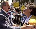 "George W. Bush talks to supporter Rosario Marin at La Raza's conference in San Diego"
